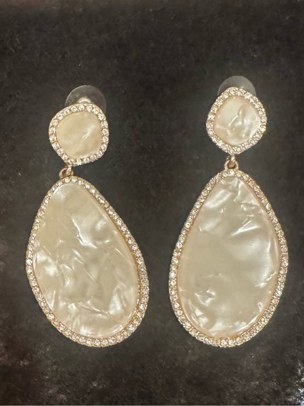 Costume mother of pearl earrings with sparkles. Solid costume piece.